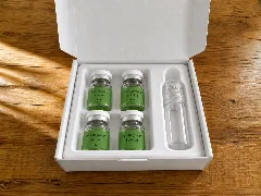 The open box with four serum vials and the microneedle in place